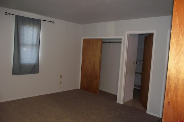 unfurnished bedroom featuring carpet flooring and a closet