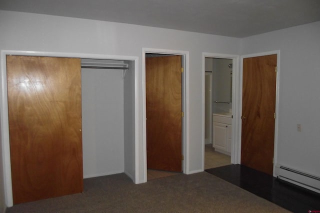 unfurnished bedroom featuring a baseboard radiator and light colored carpet