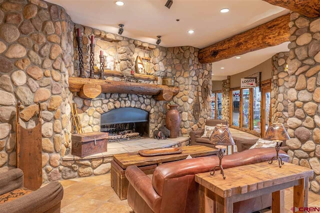 living room featuring a stone fireplace and beam ceiling