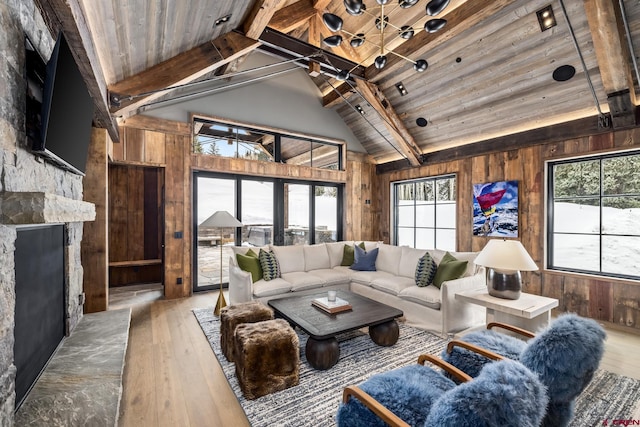 living room featuring wooden ceiling, a healthy amount of sunlight, and wood walls