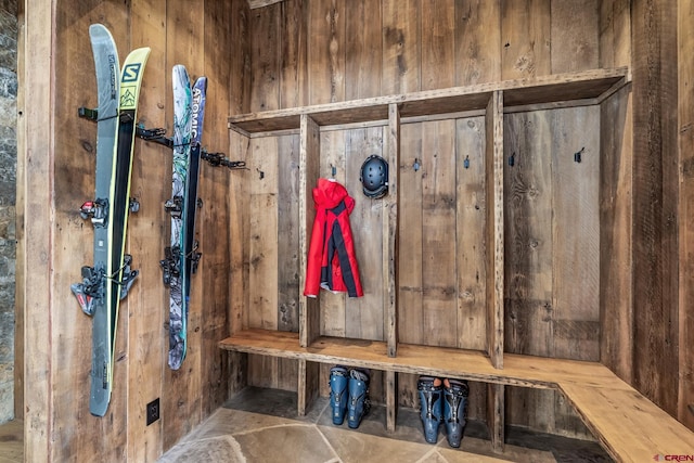 mudroom with wood walls