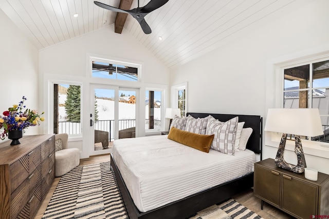 bedroom with ceiling fan, beam ceiling, high vaulted ceiling, and access to outside