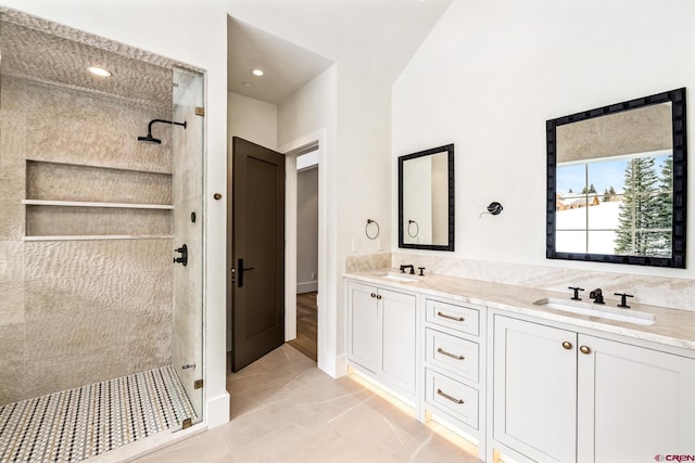 bathroom with vanity and a tile shower