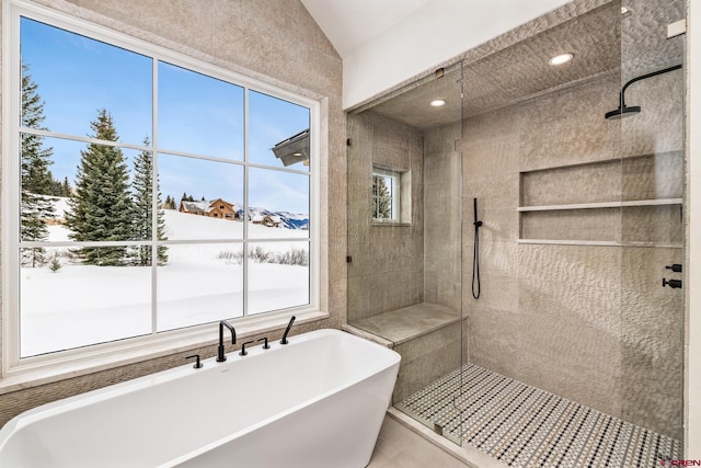 bathroom with lofted ceiling and shower with separate bathtub