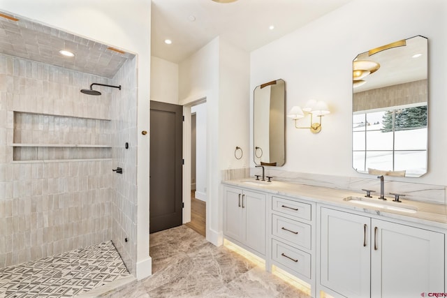 bathroom featuring vanity and tiled shower