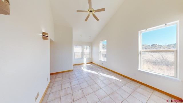 tiled spare room with high vaulted ceiling and ceiling fan