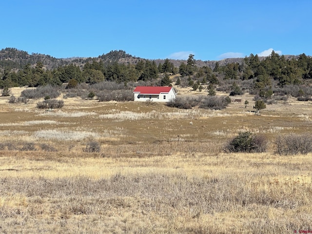 mountain view featuring a rural view