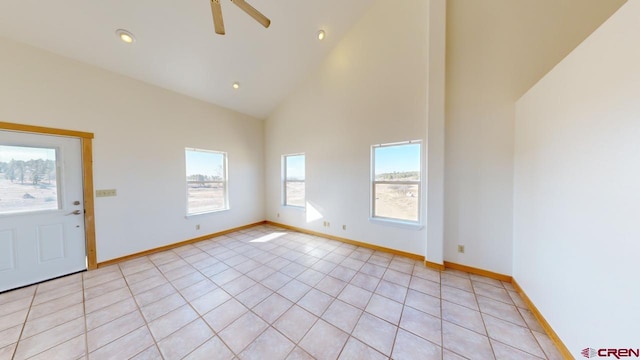 interior space featuring light tile patterned floors, high vaulted ceiling, and ceiling fan