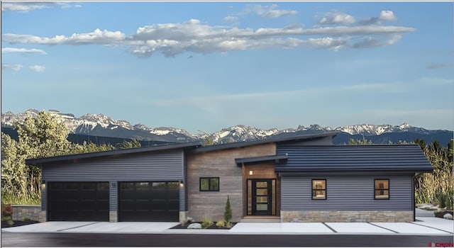 view of front of house with a garage and a mountain view