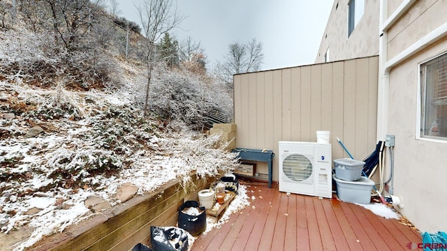 snow covered deck featuring ac unit