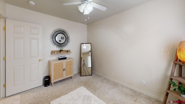 interior space with ceiling fan