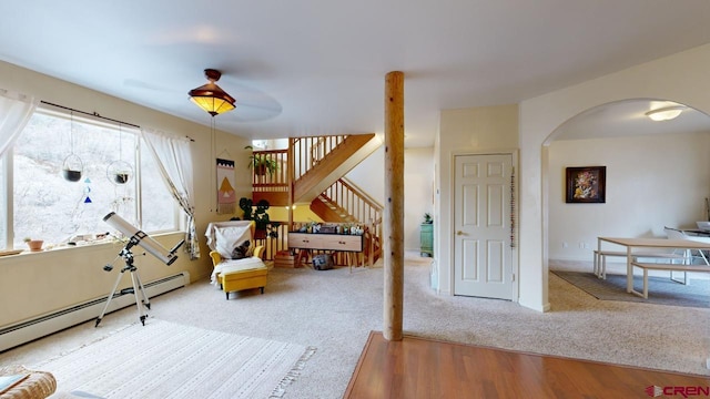 sitting room featuring a baseboard radiator and hardwood / wood-style floors