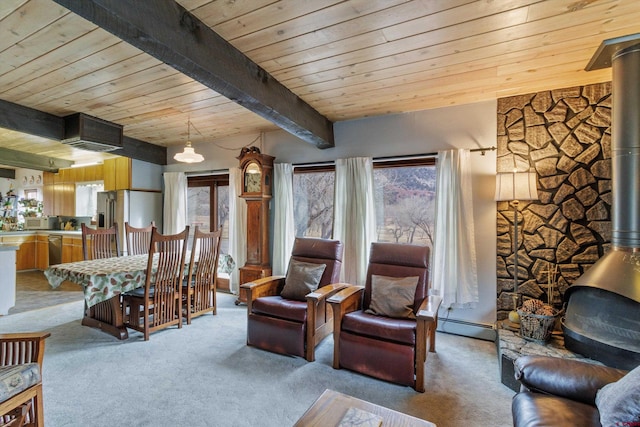 carpeted living room featuring a baseboard heating unit, a wood stove, wooden ceiling, and beam ceiling