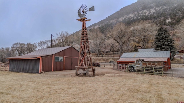 view of yard featuring a mountain view and an outbuilding