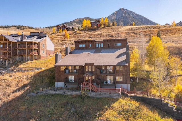 back of property featuring a mountain view