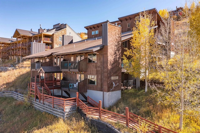 back of property with a balcony