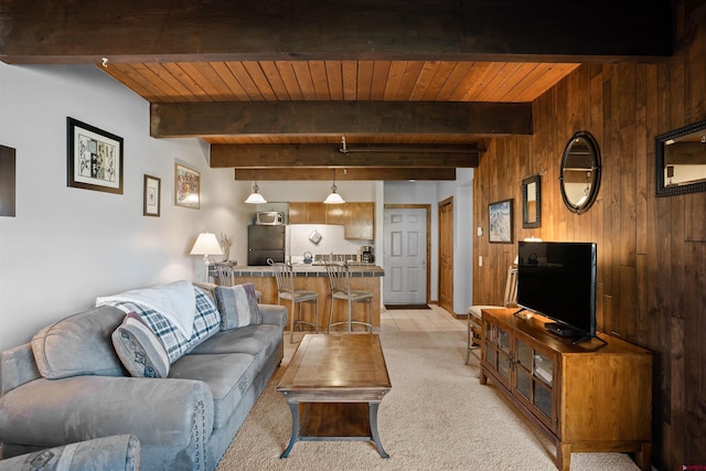 living room with wood ceiling, light colored carpet, beamed ceiling, and wood walls