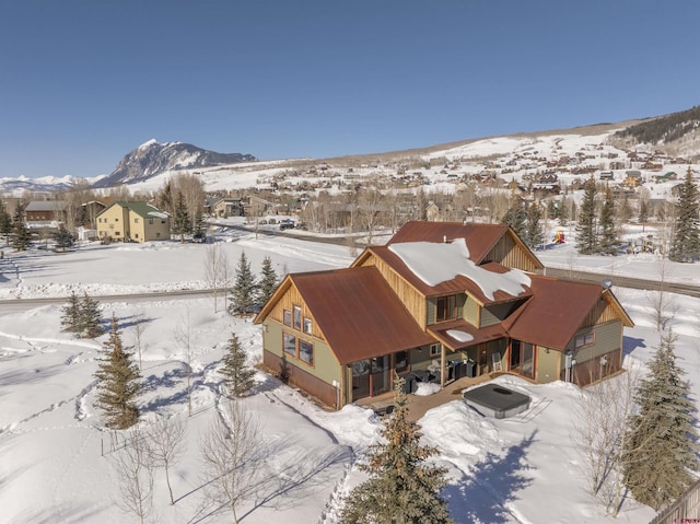 snowy aerial view with a mountain view