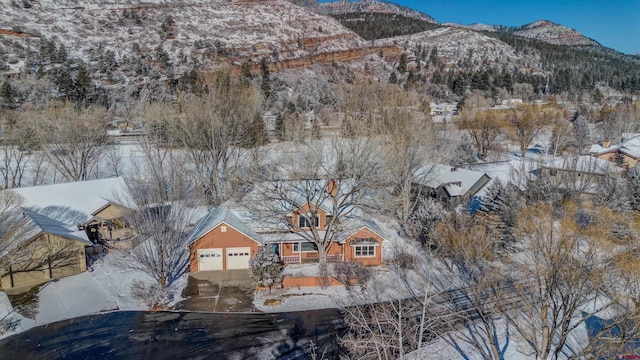 snowy aerial view with a mountain view