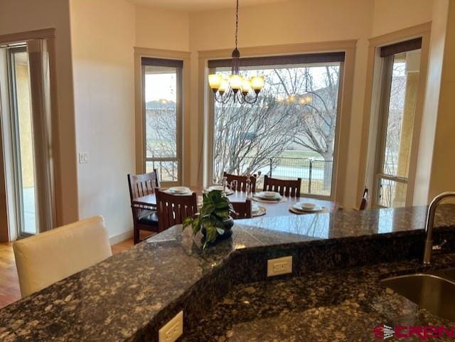 dining area with sink and a notable chandelier