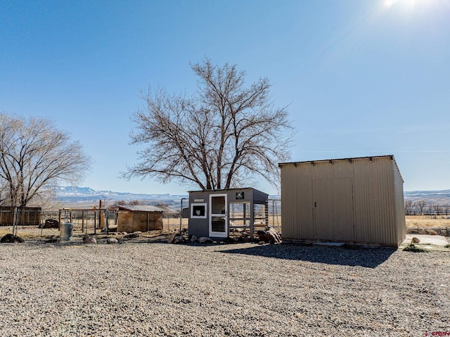 view of yard with an outdoor structure and a mountain view