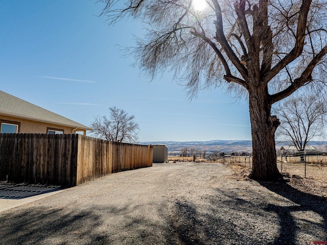 view of yard with a mountain view and a rural view