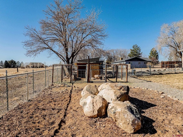 view of yard with a rural view and an outbuilding