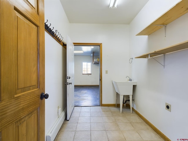 washroom with electric dryer hookup and a baseboard heating unit