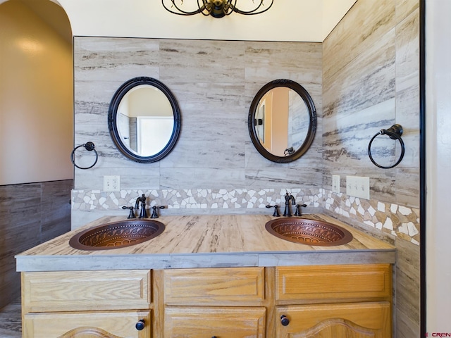 bathroom with tasteful backsplash and vanity