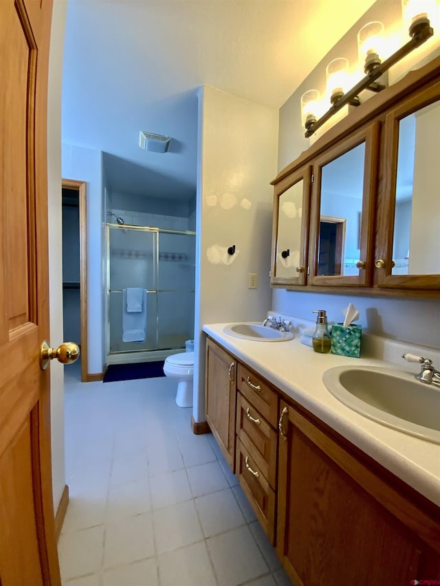 bathroom with walk in shower, vanity, and toilet