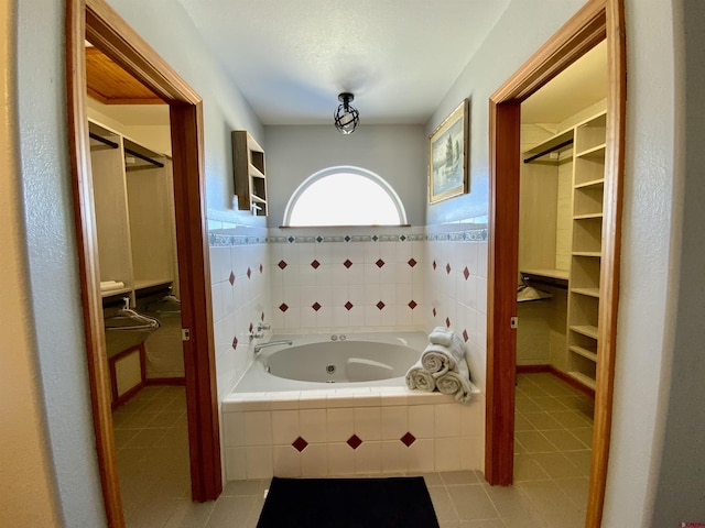 bathroom featuring tile patterned floors and tiled tub