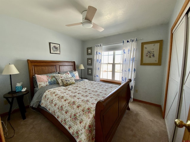 carpeted bedroom with ceiling fan and a closet