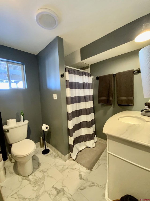 bathroom with vanity, toilet, and walk in shower