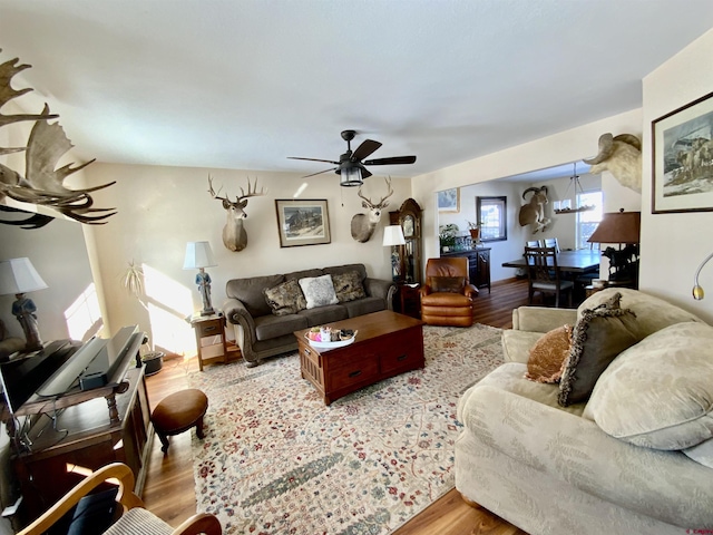 living room with light hardwood / wood-style flooring and ceiling fan