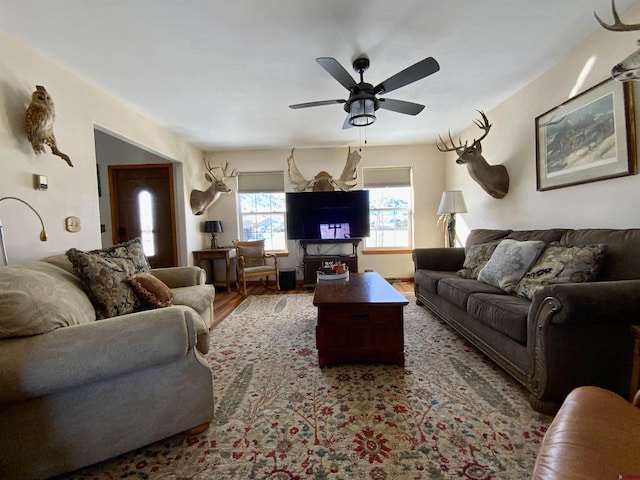 living room featuring ceiling fan and wood-type flooring