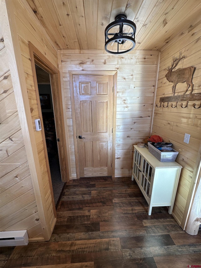 mudroom featuring dark wood-type flooring, wooden walls, and wooden ceiling