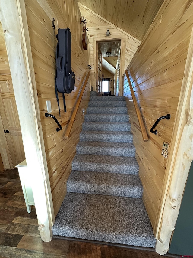 stairway featuring wood ceiling, vaulted ceiling, hardwood / wood-style flooring, and wood walls