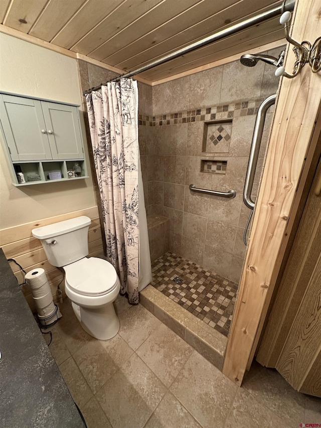 bathroom featuring curtained shower and toilet