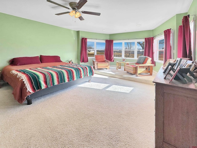 bedroom featuring ceiling fan and carpet