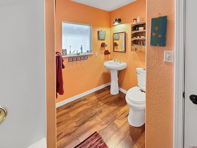 bathroom featuring hardwood / wood-style flooring, sink, and toilet