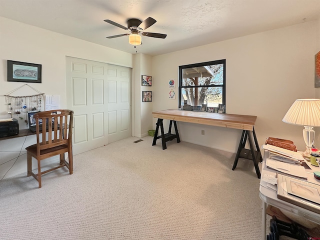 carpeted home office with ceiling fan