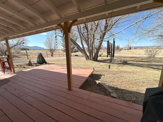 wooden terrace featuring a mountain view and a rural view