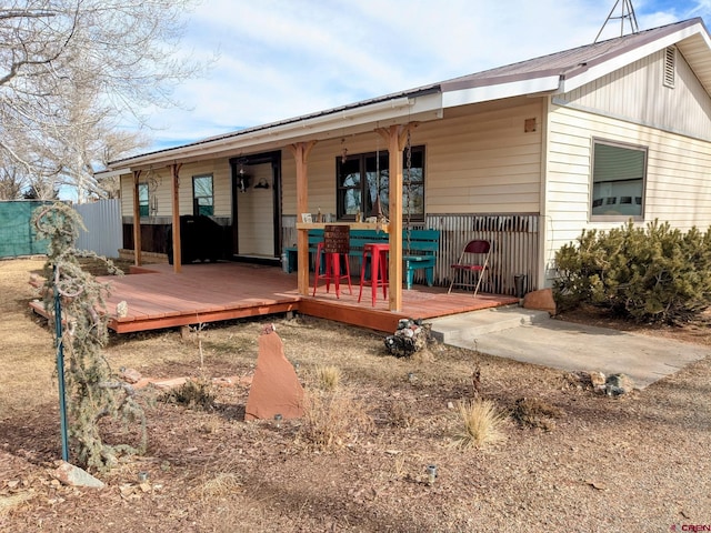 rear view of house with a wooden deck