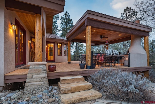 wooden deck featuring ceiling fan