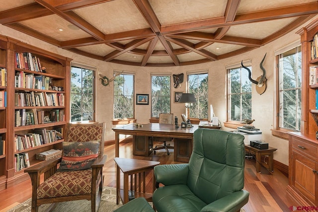 sitting room featuring a healthy amount of sunlight, wood-type flooring, coffered ceiling, and beam ceiling