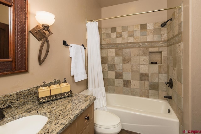 full bathroom with vanity, shower / bath combination with curtain, and toilet