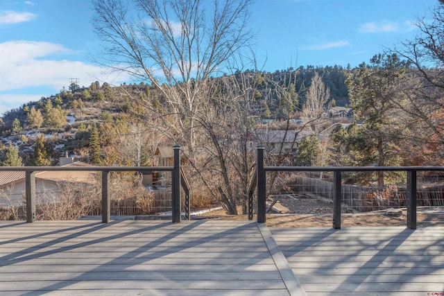 deck with fence and a mountain view