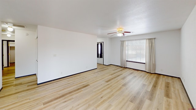 empty room with light hardwood / wood-style flooring and ceiling fan