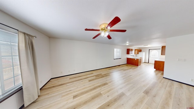 unfurnished living room with ceiling fan and light hardwood / wood-style flooring