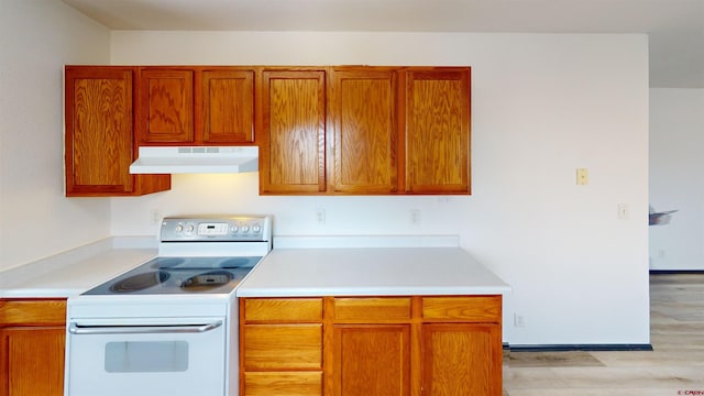 kitchen featuring white electric range and light hardwood / wood-style floors